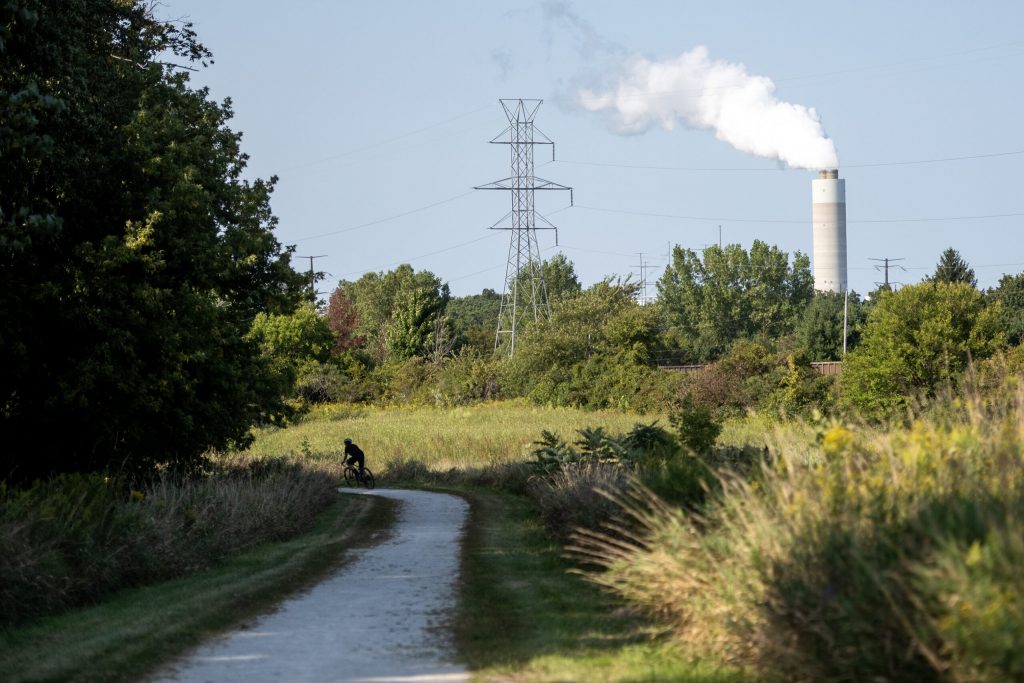 A bicyclist rides on a trail near the We Energies Oak Creek Power Plant on Monday, Sept. 8, 2025, in Caledonia, Wis. Angela Major/WPR
