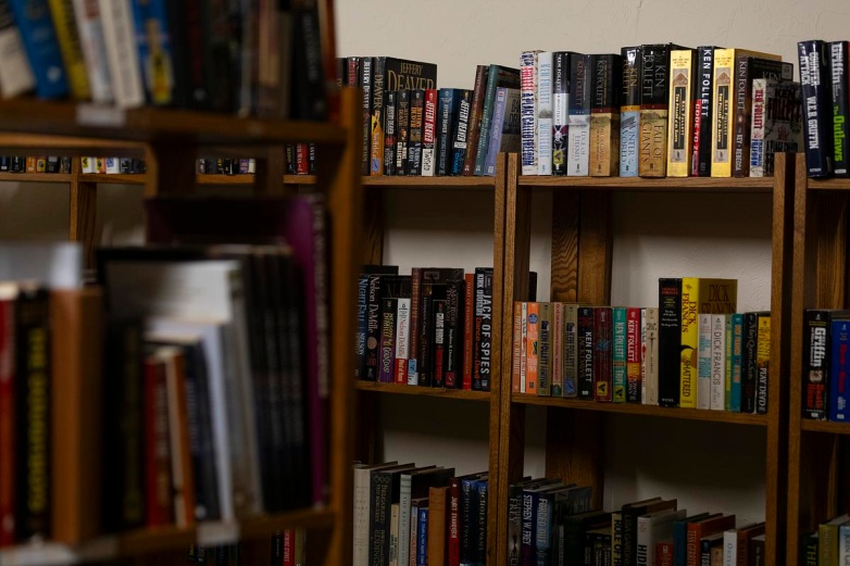 Books are stacked on the shelves in the library, Monday, Aug. 25, 2025, at Klein Hall in Chippewa Falls, Wis. (Joe Timmerman / Wisconsin Watch)