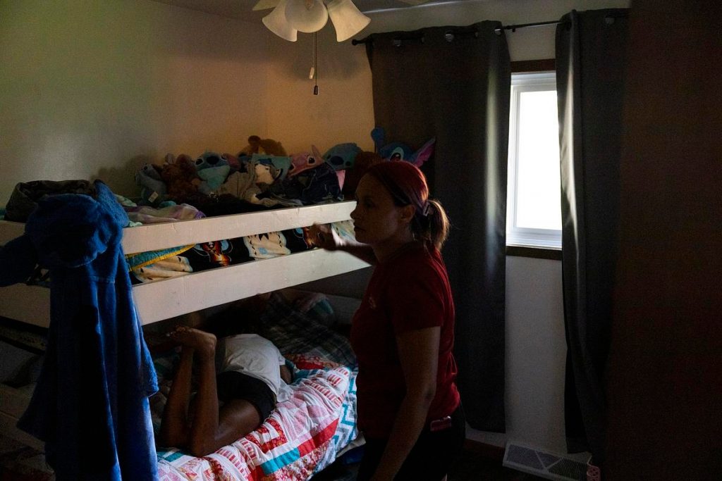 Tracy Germait, who has been waiting more than two years for a public defender, talks to her daughter, Isis, in her room on Aug. 12, 2025, at her transitional housing unit in Green Bay, Wis. (Joe Timmerman / Wisconsin Watch)