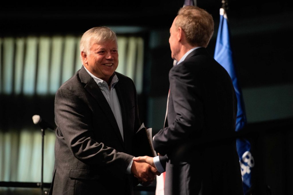 Mount Pleasant Village President David DeGroot, left, shakes hands with Vice Chair and President of Microsoft Brad Smith, right, during an event Thursday, Sept. 18, 2025, in Racine, Wis. Angela Major/WPR