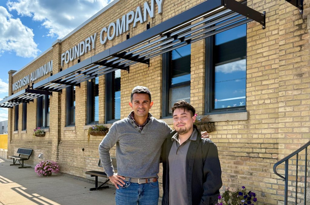 Wisconsin Aluminum Foundry CEO Sachin Shivaram, left, stands with Josue Rodriguez outside the company’s plant in Manitowoc. Photo courtesy of Wisconsin Aluminum Foundry
