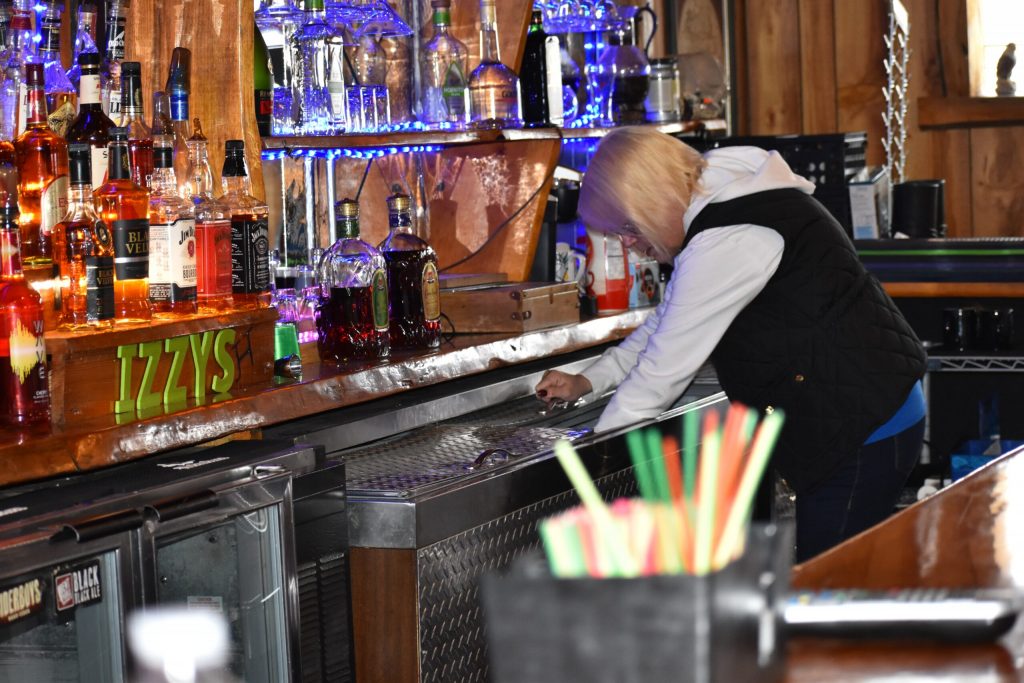 Tina Breimon, Izzy’s Bar bartender and manager, said they’re making liquor orders and cleaning the bar to prepare it for customers. Danielle Kaeding/WPR