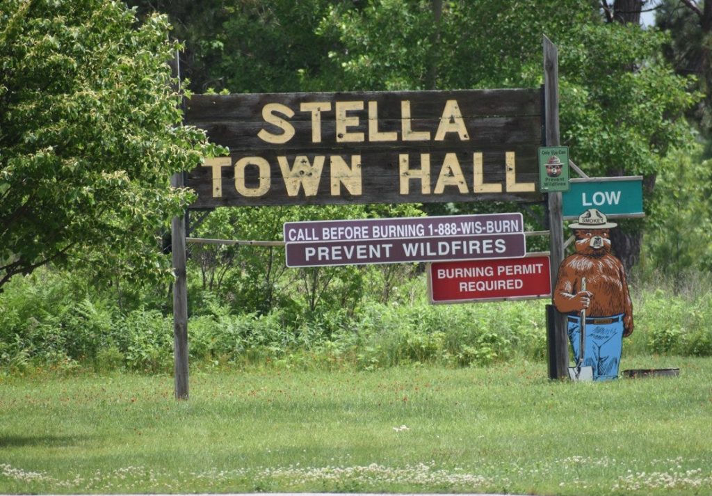 The town of Stella in Oneida County has been facing PFAS contamination of private wells and the Moen Lake Chain. A sign for the town hall is pictured here on June 21, 2025. Danielle Kaeding/WPR