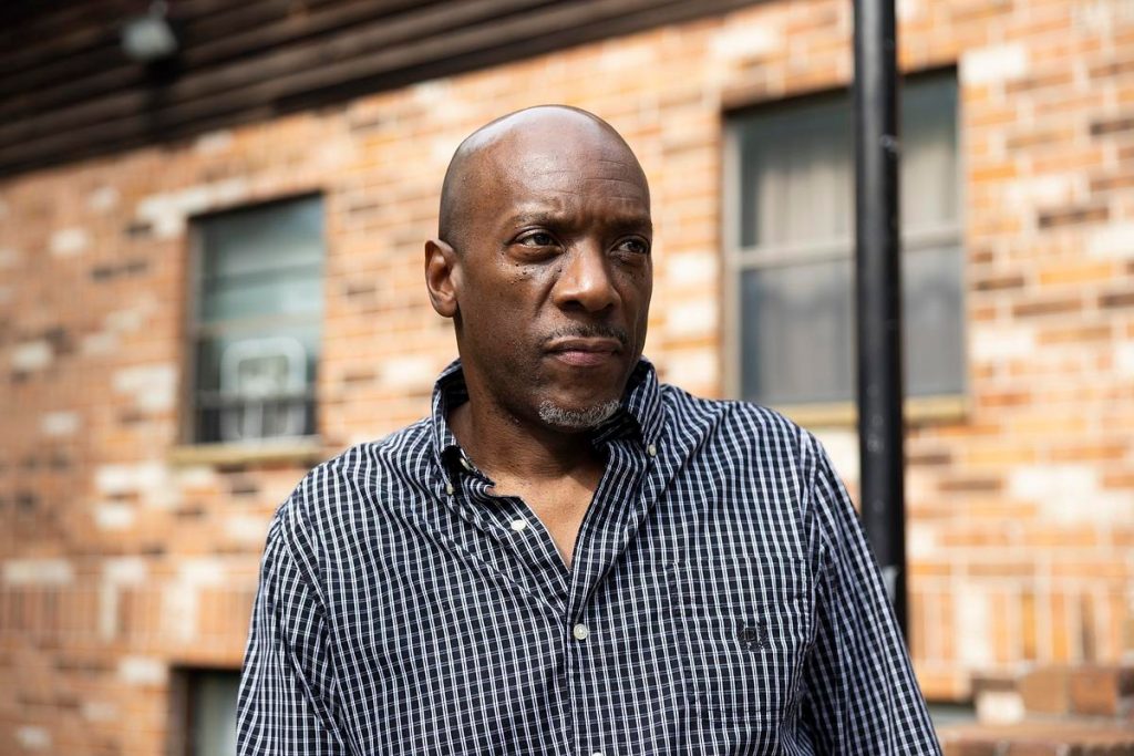Darnell Price poses for a portrait outside of his apartment building, Oct. 1, 2025, in Milwaukee. Price was granted compassionate release from prison in August 2023 after eight years behind bars due to his stage four cancer diagnosis. (Joe Timmerman / Wisconsin Watch)