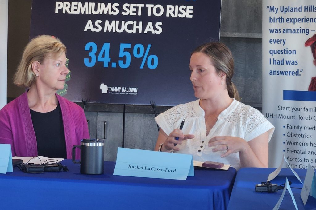 Rachel LaCasse-Ford, right talks to Sen. Tammy Baldwin about her use of the Affordable Care Act marketplace to buy insurance during a meeting Baldwin held with small business owners and others in Mount Horeb, Wisconsin, on Sept. 25. (Photo by Erik Gunn/Wisconsin Examiner)