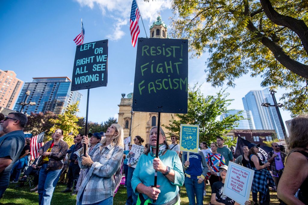 People gather during a No Kings protest in opposition to President Trump on Saturday, Oct. 18, 2025, at Cathedral Square Park in Milwaukee, Wis. Angela Major/WPR