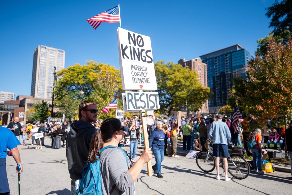 Protesters gather before an anti-Trump march Saturday, Oct. 18, 2025, at Cathedral Square Park in Milwaukee, Wis. Angela Major/WPR