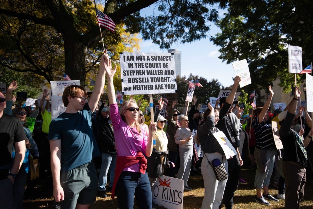 Protesters gather in opposition to President Donald Trump during a No Kings Protest on Saturday, Oct. 18, 2025, at Cathedral Square Park in Milwaukee, Wis. Angela Major/WPR