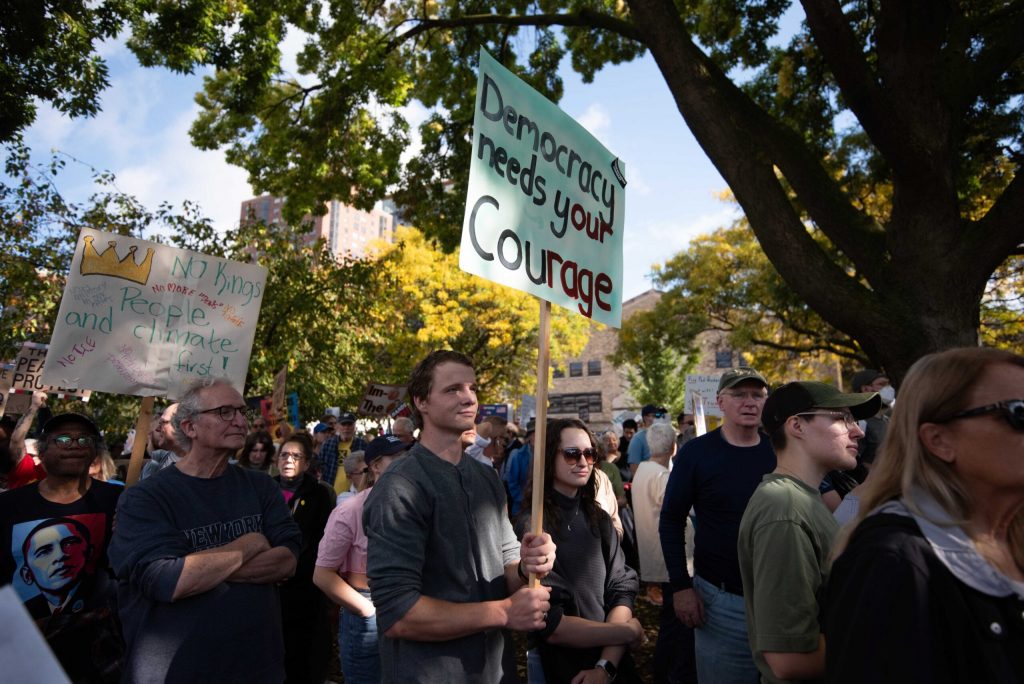 Protesters gather in opposition to President Donald Trump during a No Kings Protest on Saturday, Oct. 18, 2025, at Cathedral Square Park in Milwaukee, Wis. Angela Major/WPR