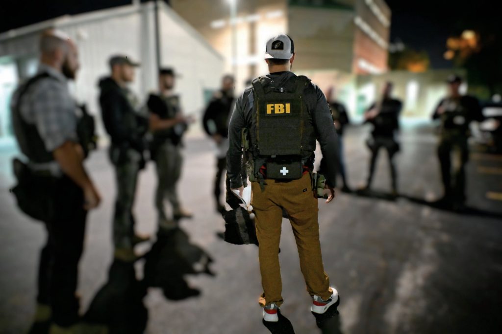 An FBI agent stands around what appears to be other members of law enforcement. The FBI’s Milwaukee office posted this image to social media on Sept. 25, 2025. Photo courtesy of the FBI