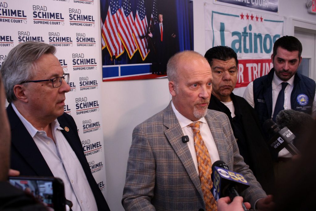 Following the April state Supreme Court loss, Republican Party of Wisconsin Chair Brian Schimming launched an effort to examine what went wrong led by state Treasurer John Leiber. Schimming, Brad Schimel, Milwaukee pastor Marty Calderon and Fond du Lac County District Attorney Eric Toney pictured answer questions from the press in February 2025. (Henry Redman | Wisconsin Examiner)