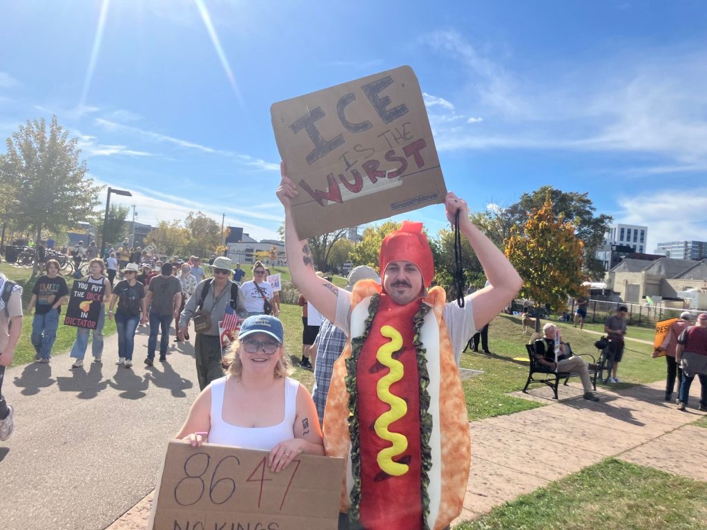 Leo Thull, right, of McFarland donned a hot dog suit at Madison’s protest to ‘be more ridiculous than they are,’ he said. He was joined by his wife, Nat Thull Sarah Lehr/WPR
