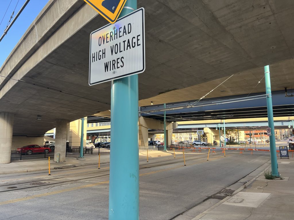 Overhead wire warning in front of portion of streetcar overhead wire system that was struck on N. Milwaukee Street. Photo by Jeramey Jannene.