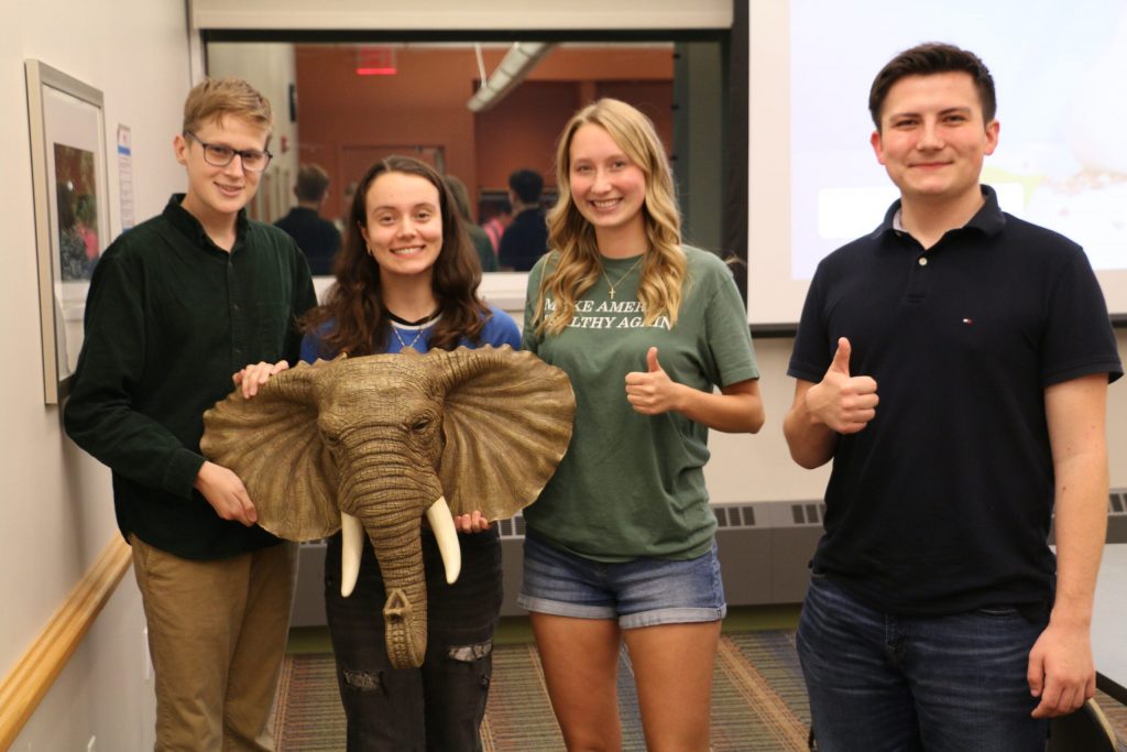 Members of the UW-River Falls College Republicans pose with their chapter mascot, an elephant head named Hector. From left to right, Dylan Stryhn, Isa Blett, chapter Chair Maddie Nelson and chapter Vice Chair Nick Jacobs. Rich Kremer/WPR