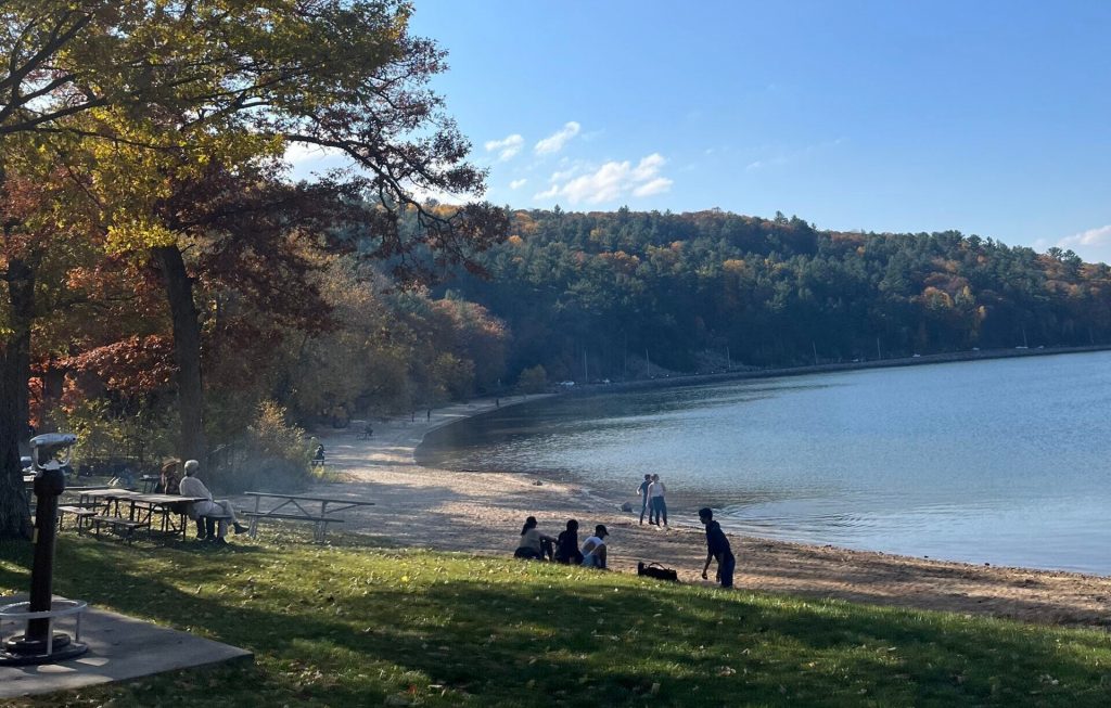 A few people sit by the beach at Devil’s Lake State Park in November 2022. Alyssa Allemand/WPR