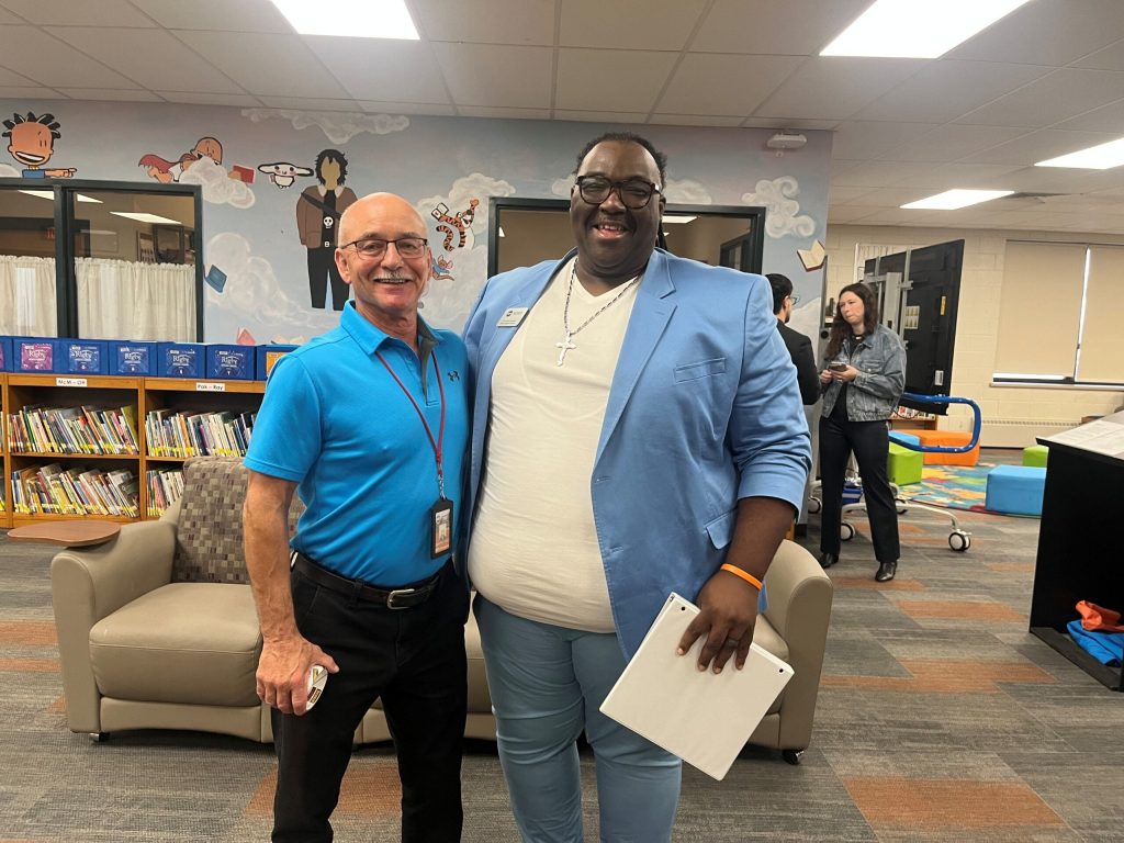 Joe Conti, left, is a retired teacher who is back at Milwaukee Public Schools. He taught School Board Member James Ferguson when Ferguson was in seventh grade. Corrinne Hess/WPR