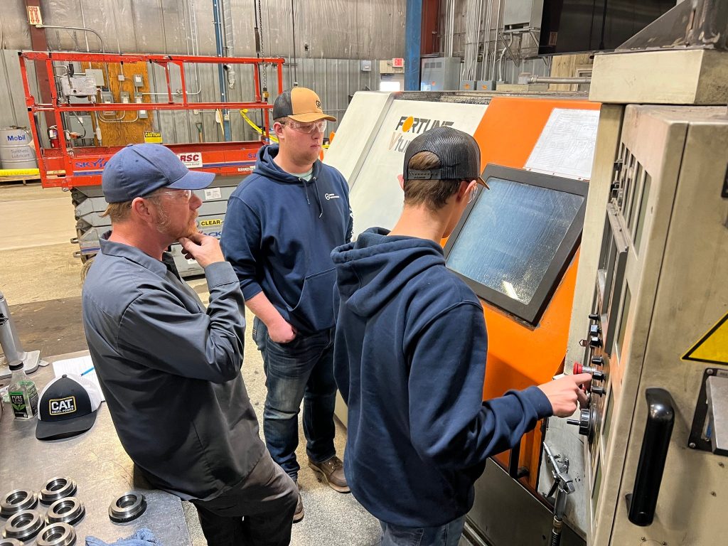 Students in Superior high school’s Spartan Manufacturing program learn to operate a CNC lathe to create products that are sold and marketed by real businesses in the region. Photo courtesy of Spartan Manufacturing