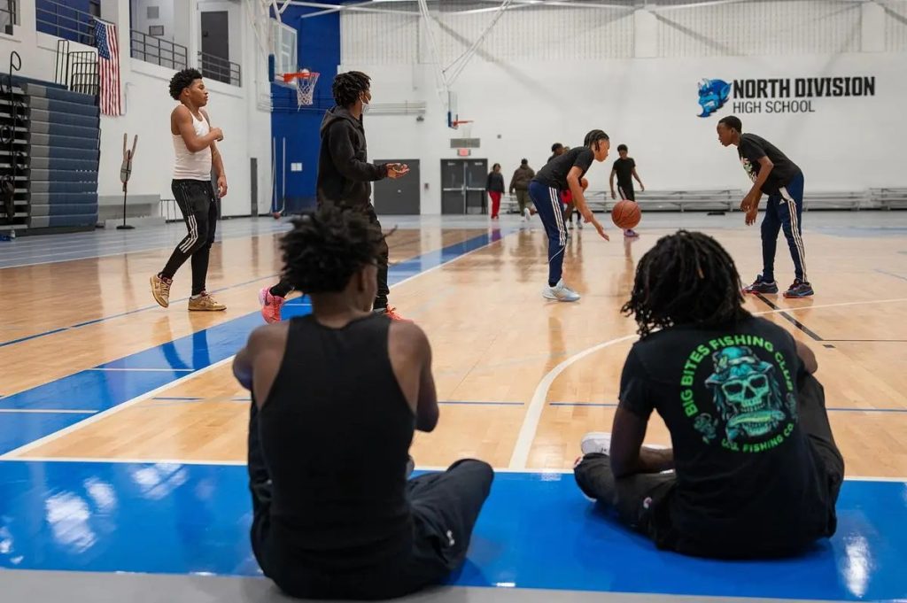 Students play basketball while others watch at North Division High School’s Twilight Center. (Photo by Jonathan Aguilar / Milwaukee Neighborhood News Service / CatchLight Local)