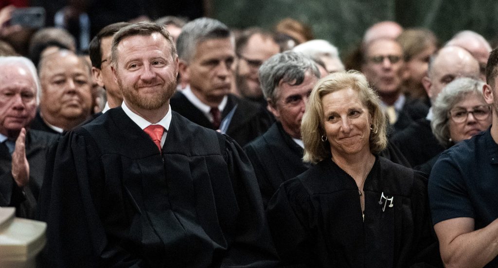 Wisconsin Supreme Court Justices Brian Hagedorn, left, and Jill Karofsky, right, sit together during Justice-elect Janet Protasiewicz’s investiture Tuesday, Aug. 1, 2023, at the Wisconsin State Capitol in Madison, Wis. Angela Major/WPR