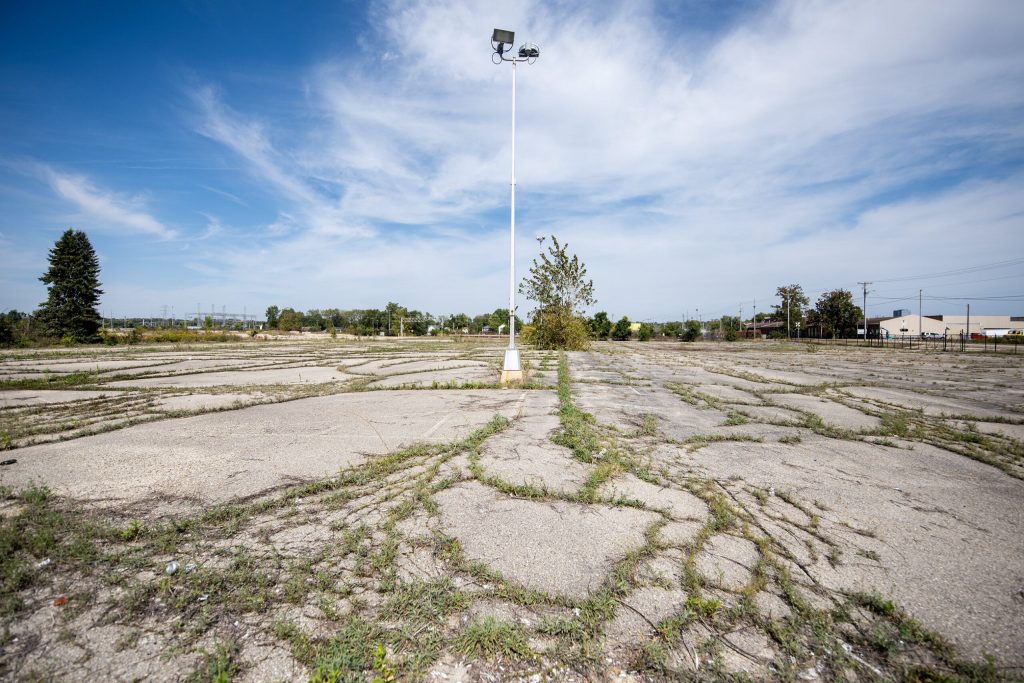 Grass grows through cracks in concrete at the site of the former General Motors assembly plant Friday, Sept. 13, 2024, in Janesville, Wis. Angela Major/WPR