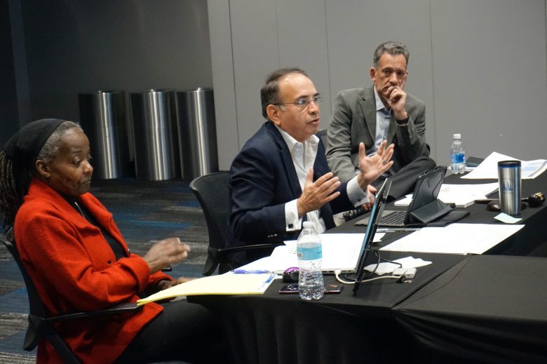 Social Development Commission Interim CEO and Board Chair Jorge Franco (center) discusses SDC's finances, as Diane Robinson (left), chief operating officer and executive director, and Aaron Hurvitz (right), chief communications officer, listen during a board meeting on Thursday, Oct. 30. (Photo by Meredith Melland)