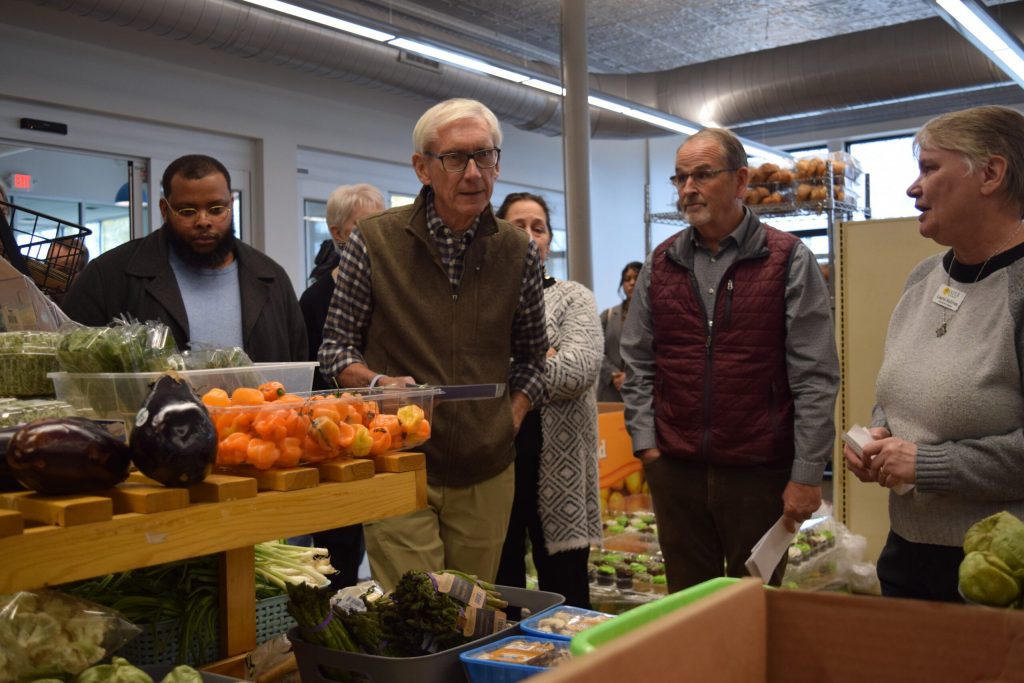 Gov. Tony Evers discusses increased need for food assistance with leaders of WAFER Food Pantry in La Crosse on Monday, Nov. 10, 2025. Hope Kirwan/WPR