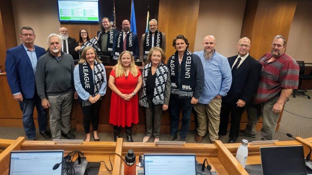 City of Green Bay officials take a photo with Justin Papadakis of the United Soccer League, fourth from the right, during a Nov. 11 City Council meeting. Photo courtesy of the city of Green Bay