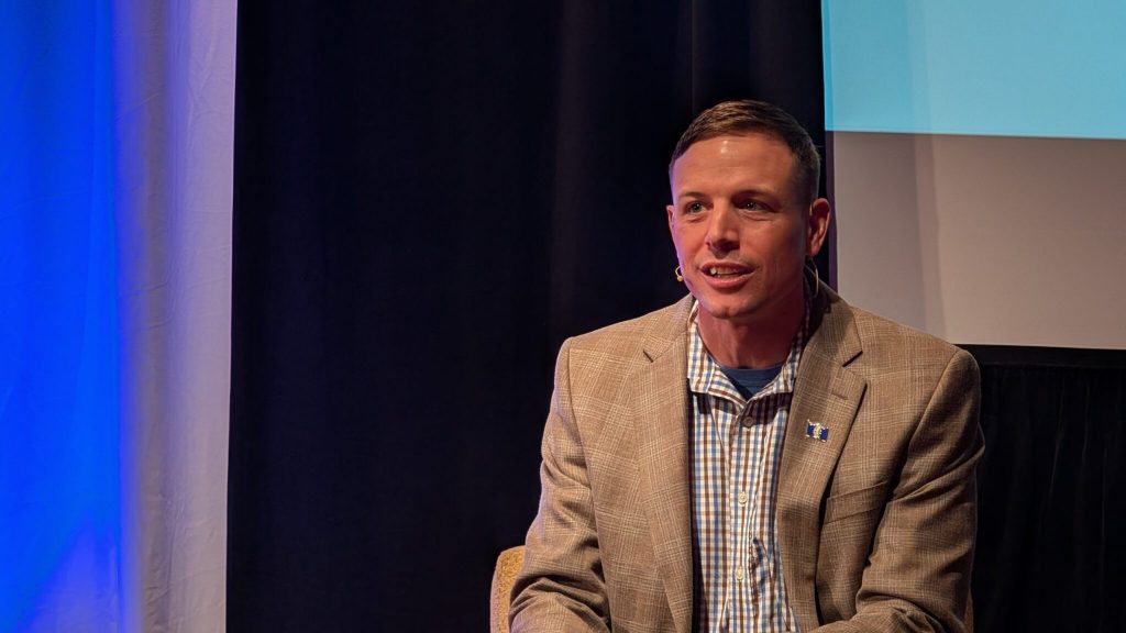 Washington County Executive Josh Schoemann speaks at the first candidate forum of the campaign cycle. He said “affordability” is the greatest threat and expressed concerns about young people and retirees leaving the state to live elsewhere. (Photo by Baylor Spears/Wisconsin Examiner)