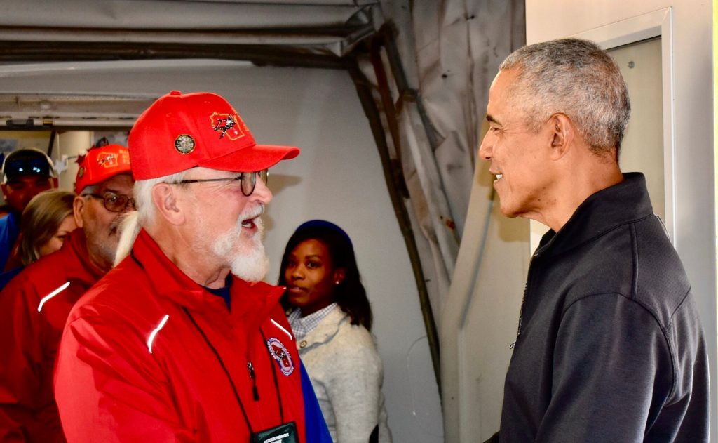 Former President Barack Obama shakes hands with a veteran traveling with Badger Honor Flight on Saturday, Nov. 9, 2025. Photo from Barack Obama’s public social media page