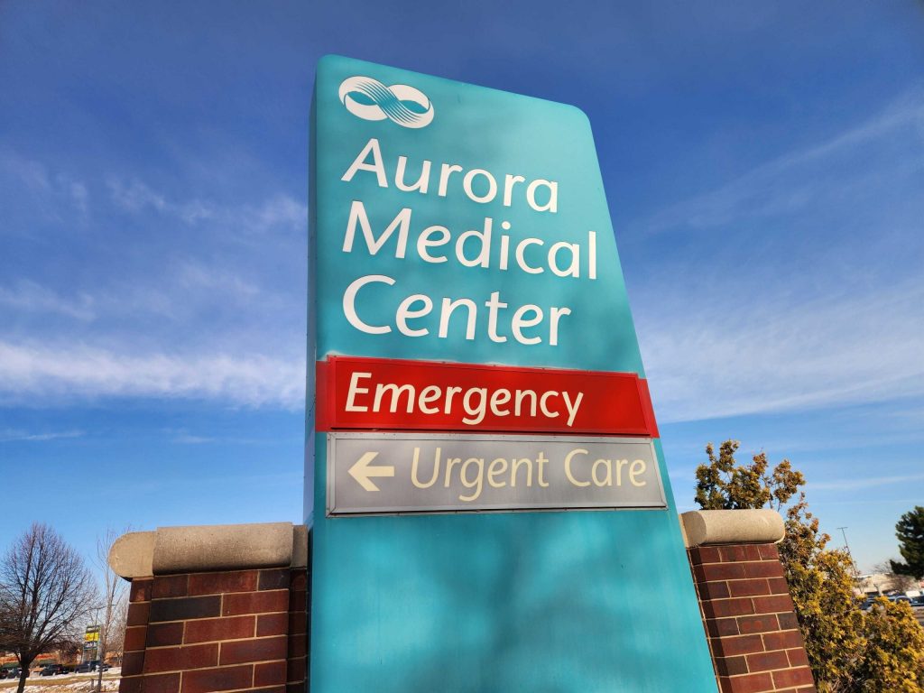The sign near the enterance to Advocate Aurora Health’s Aurora Medical Center Hospital in Oshkosh is seen on Dec. 23, 2025. Joe Schulz/WPR