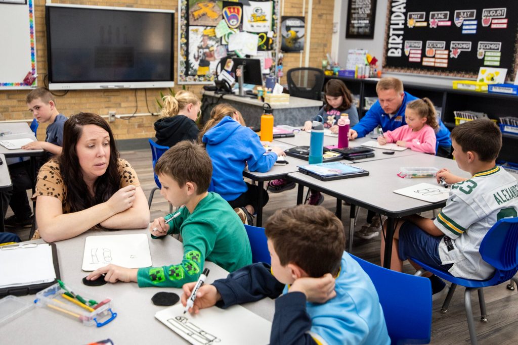 Third grade teacher Karly Enloe works with students during a math lesson Tuesday, April 29, 2025, at Winskill Elementary School in Lancaster, Wis. Angela Major/WPR