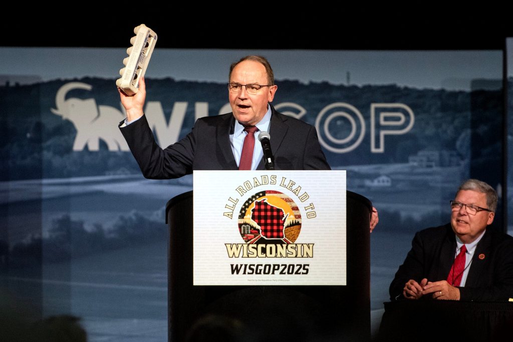 U.S. Rep. Tom Tiffany holds an egg carton as he begins his speech Saturday, May 17, 2025, during the Republican Party of Wisconsin State Convention in Rothschild, Wis. Angela Major/WPR