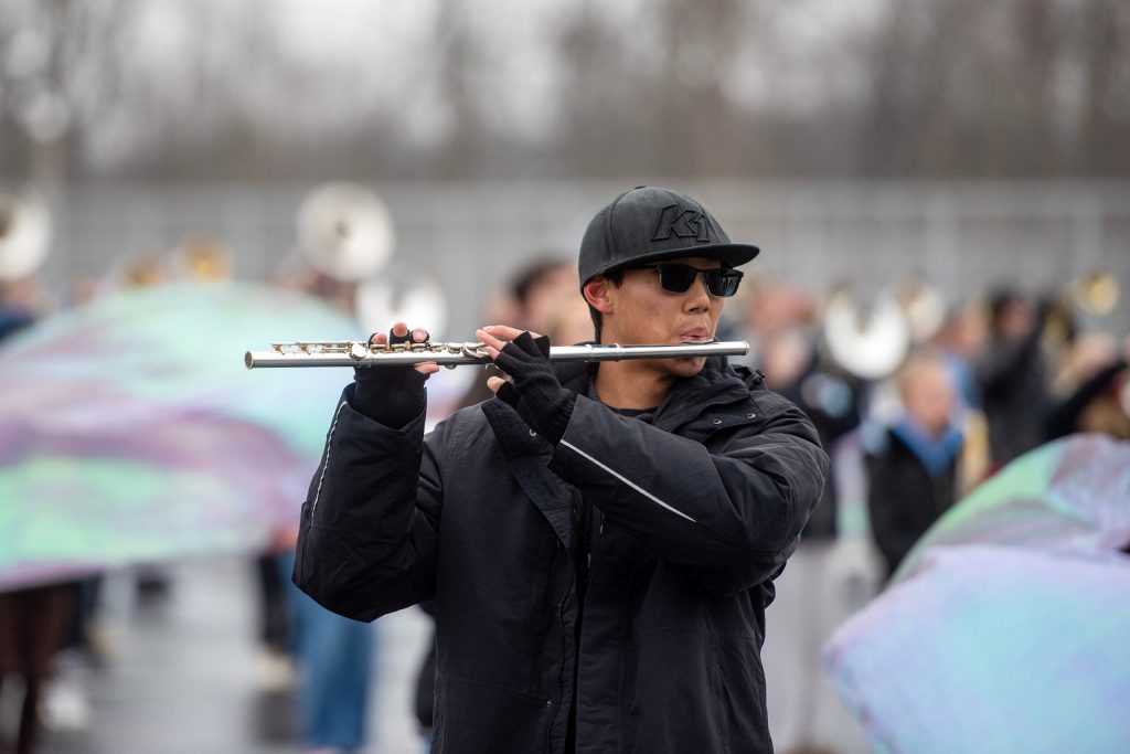 Ethan Bowe, a Greendale High School band flutist, practices with the marching band for their upcoming Rose Parade performance Tuesday, Dec. 9, 2025, in Greendale, Wis. Angela Major/WPR
