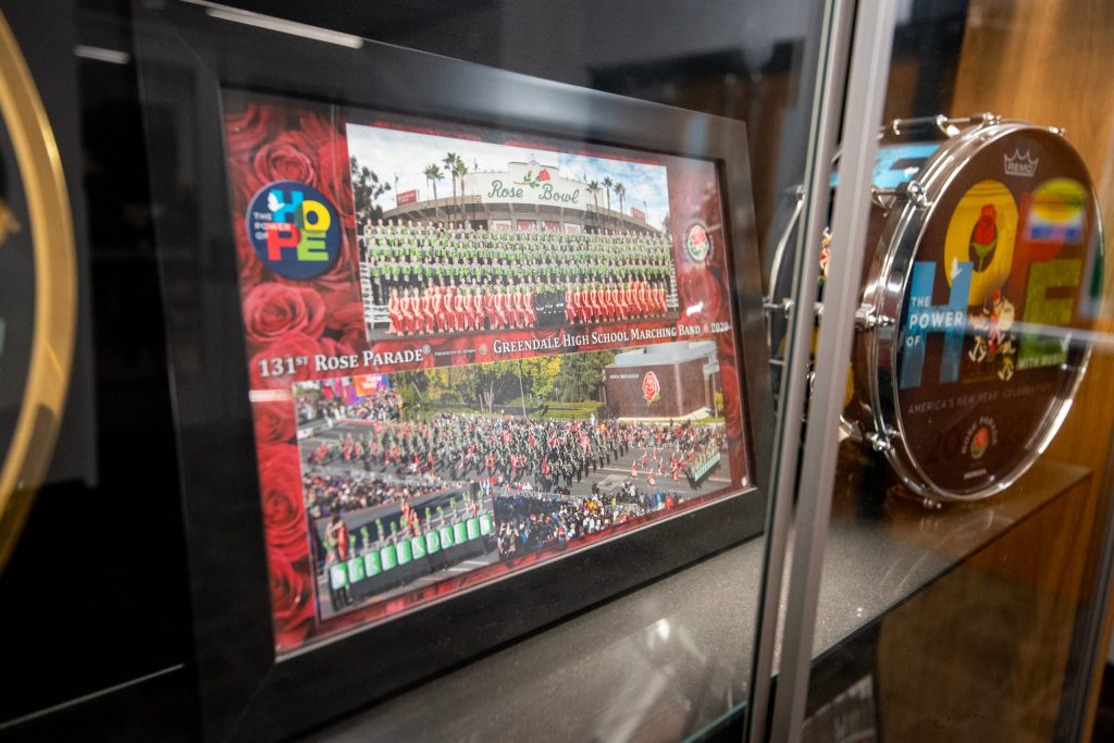 The Greendale High School band will perform in the upcoming Rose Parade. Photos of their performance are on display at the school Tuesday, Dec. 9, 2025, in Greendale, Wis. Angela Major/WPR