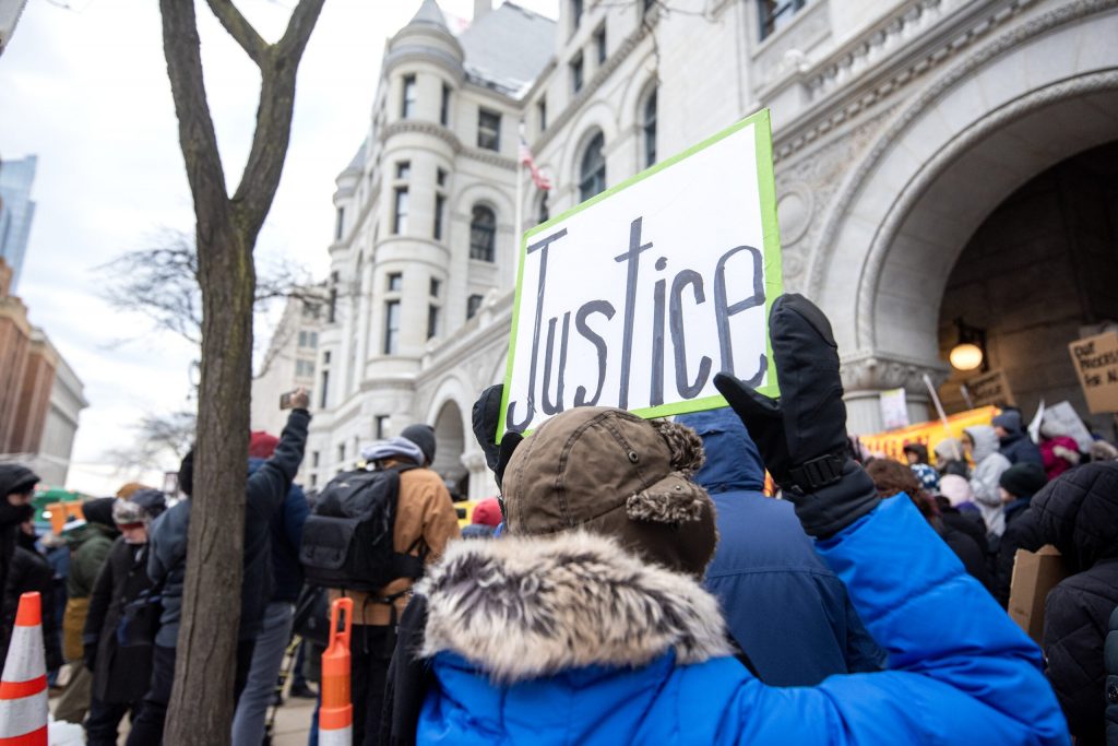 Protesters gather outside of the courthouse in support of Milwaukee County Judge Hannah Dugan on Monday, Dec. 15, 2025, at the Milwaukee Federal Building & U.S. Courthouse in Milwaukee, Wis. Angela Major/WPR