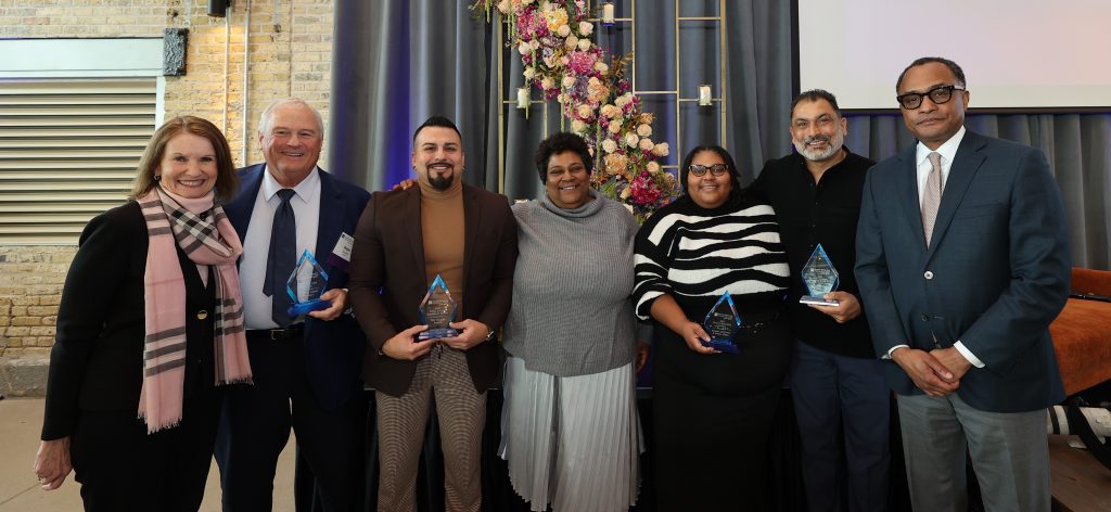 Greater Milwaukee Foundation Board Chair Mary Ellen Stanek (L) and President and CEO Greg Wesley (R), celebrate the Foundation’s 2025 Greater Together Civic Award recipients Roger Schaus (and Cindy, not pictured), Dr. Victor Amaya, Danell Cross, Melody McCurtis and Pardeep Kaleka, at the A Milwaukee for All: Leading with Impact event on Dec. 2. Photo courtesy of the Greater Milwaukee Foundation.