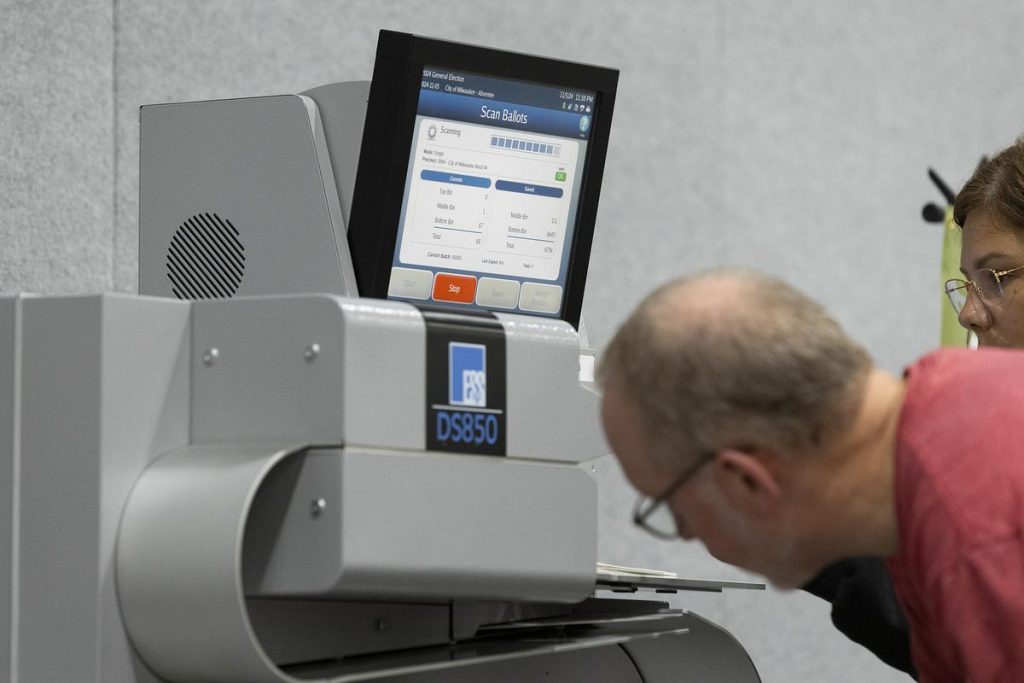 Election workers count votes using a tabulation machine during Election Day on Nov. 5, 2024, at Milwaukee’s central count facility at the Baird Center. (Joe Timmerman / Wisconsin Watch)