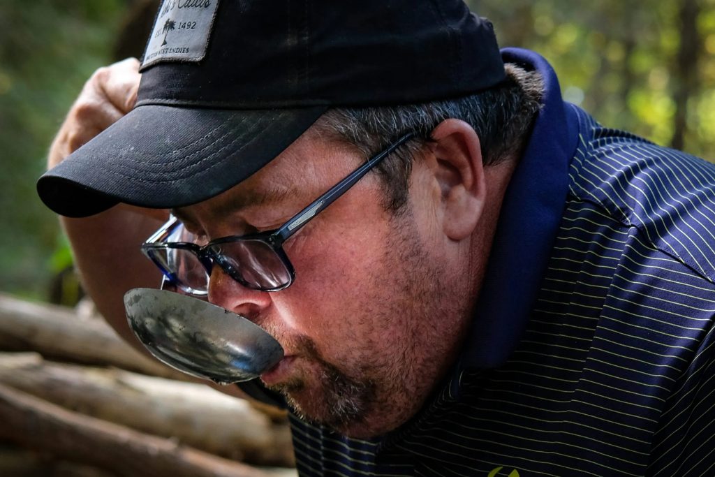 Chris Kestell drinks from Nichols Creek. Photo © Christian Thorsberg/Circle of Blue