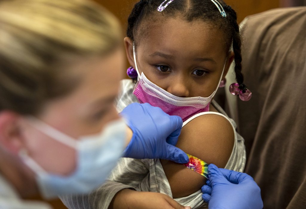 Five-year-old Kamille Phillips-Bolden gets a colorful bandage after receiving a COVID-19 vaccine Monday, Nov. 8, 2021, at Townsend Public School in Milwaukee, Wis. Angela Major/WPR