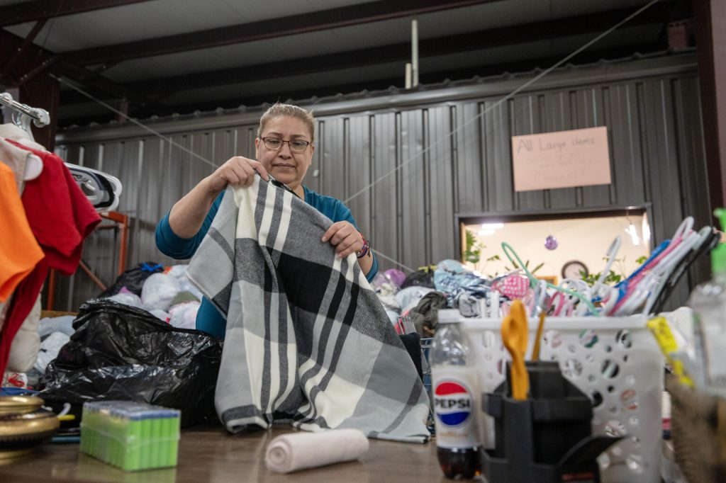 Volunteer Patricia Ortega organizes donations Wednesday, Jan. 7, 2026, at the Community Space in Whitewater, Wis. Angela Major/WPR