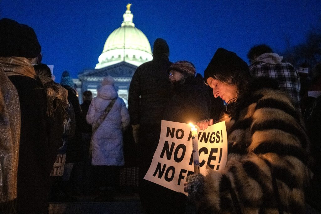 Tosha Kowalski of Madison holds a candle as she attends a vigil to remember Renee Macklin Good on Friday, Jan. 9, 2026, at the Wisconsin State Capitol in Madison, Wis. “Our government is killing American citizens,” she said. Angela Major/WPR