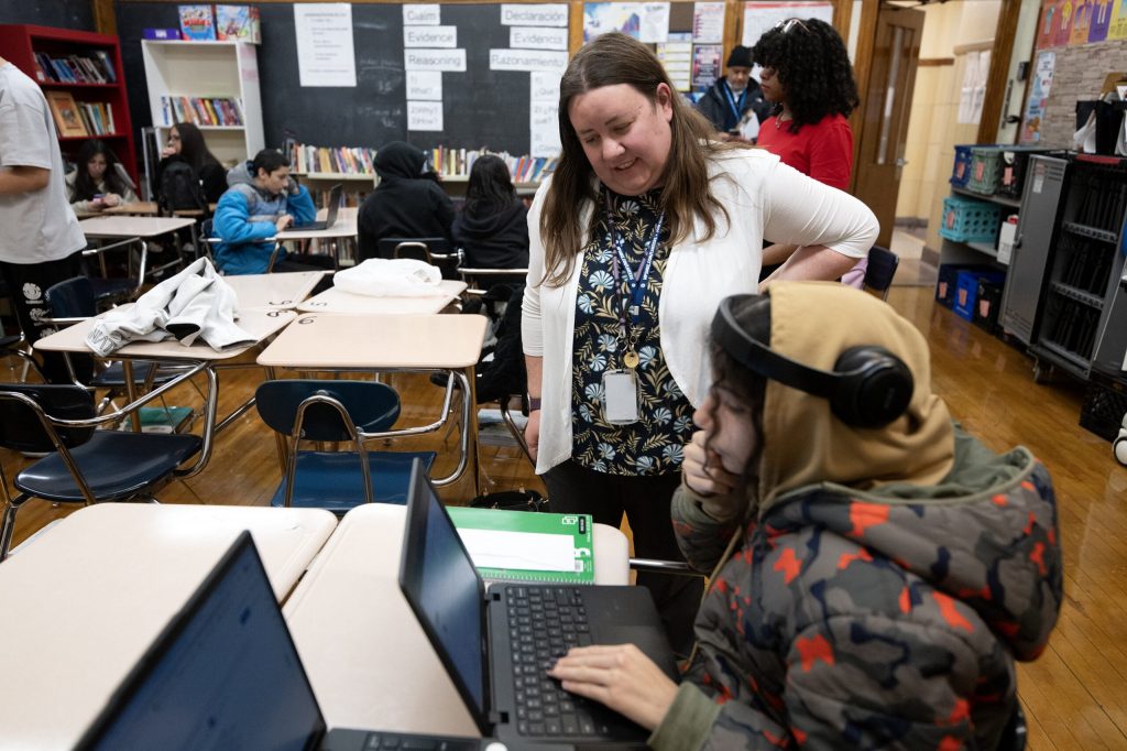 Sarah Lind encourages her student as the English class wraps up Wednesday, Jan. 14, 2026, at Casimir Pulaski High School in Milwaukee, Wis. Angela Major/WPR