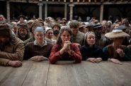 Elbows firmly on the stage's edge at the Globe Theatre, Jessie Buckley as Agnes, the mother of the deceased "Hamnet, " awaits her husband's "Hamlet." Photo courtesy of Milwaukee Film.