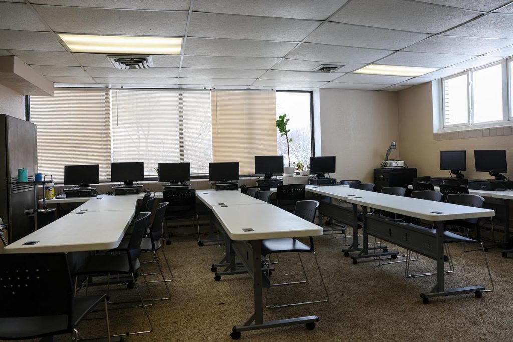 Tables and computers sit in a classroom that hosts English as a second language classes and other programs, Dec. 1, 2025, at Hanan Refugee Relief Group’s office in Milwaukee. The nonprofit cut 10 members of an already small team due to the Trump administration’s pause on most refugee admissions. (Jonathan Aguilar / Milwaukee Neighborhood News Service / CatchLight Local)