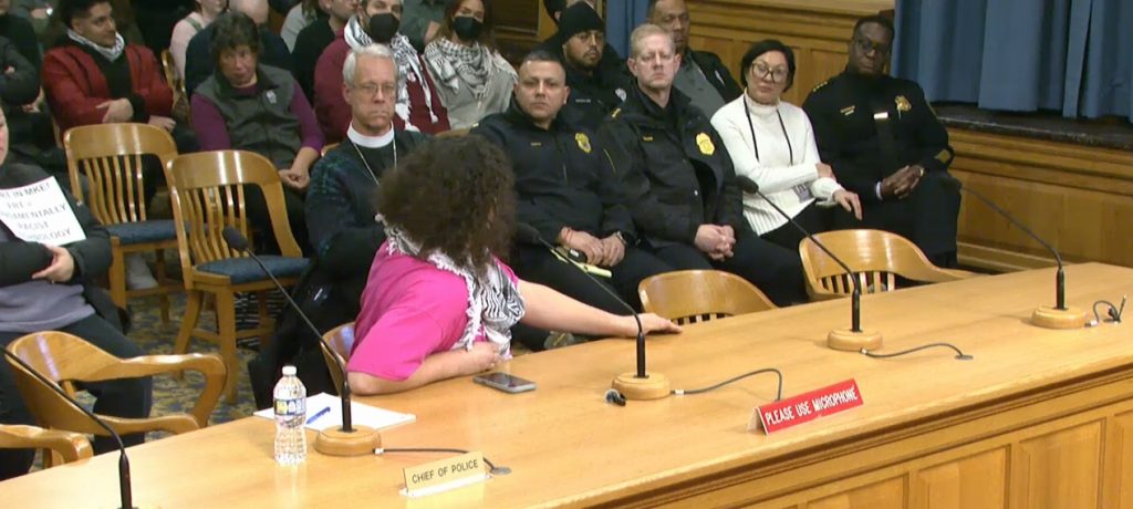 A commenter questions Jeffrey Norman during a Jan. 22 Fire & Police Commission meeting. Image from City Channel.