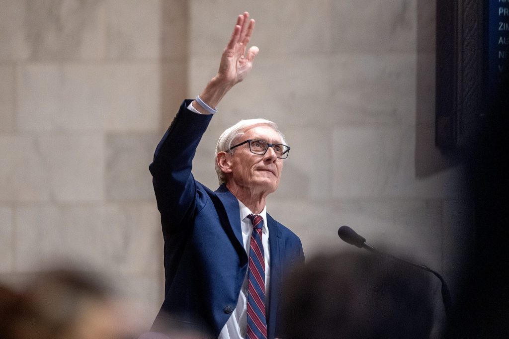 Gov. Tony Evers waves to people in the balcony before delivering the State of the State address Tuesday Feb. 17, 2026, at the Wisconsin State Capitol in Madison, Wis. Angela Major/WPR