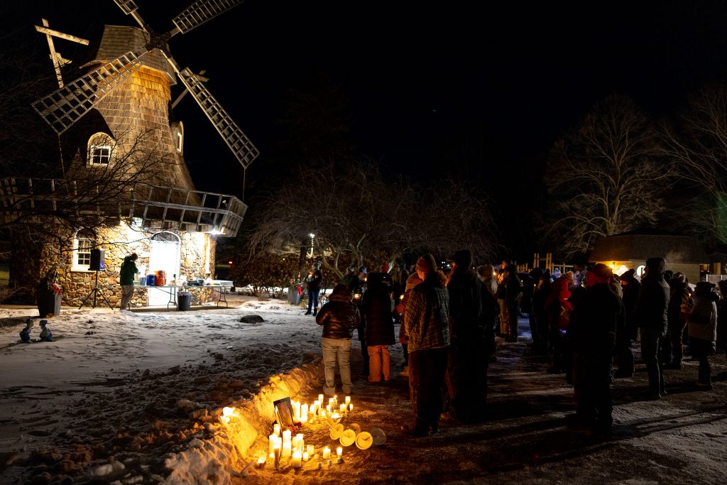 About 50 people braved sub-zero temperatures Jan. 28 to hold a candlelight vigil at Windmill Park in Baldwin for Alex Pretti and Renee Good. (Henry Redman | Wisconsin Examiner)