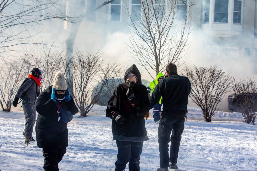 People react to tear gas and flash grenades deployed by federal agents near the scene in Minneapolis where federal agents shot and killed Alex Pretti (Photo by Nicole Neri/Minnesota Reformer)