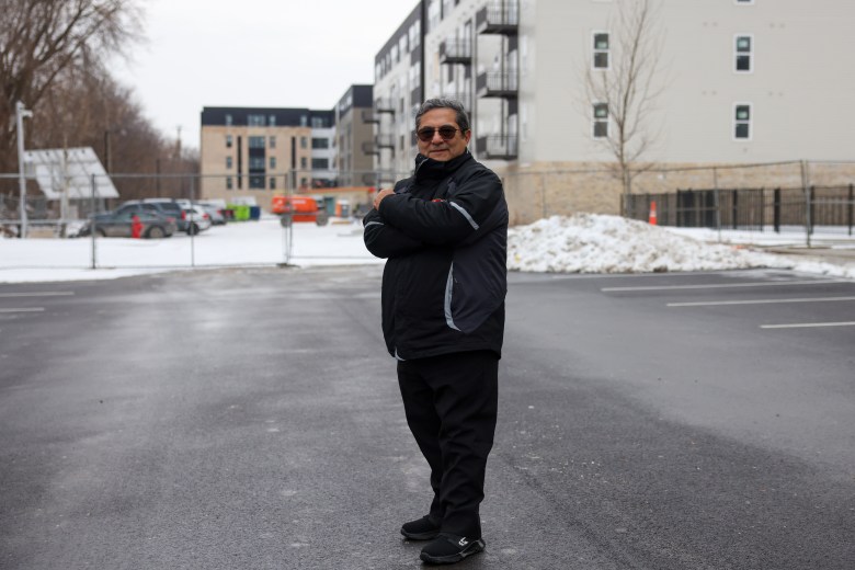 Jaime Hurtado, owner and president of Insulation Technologies Inc., said his company is still owed $112,500 for work completed for SDC. Hurtado poses for a photograph in front of an apartment complex that his company is helping complete on Thursday, Feb. 5. (Photo by Jonathan Aguilar / Milwaukee Neighborhood News Service / CatchLight Local)