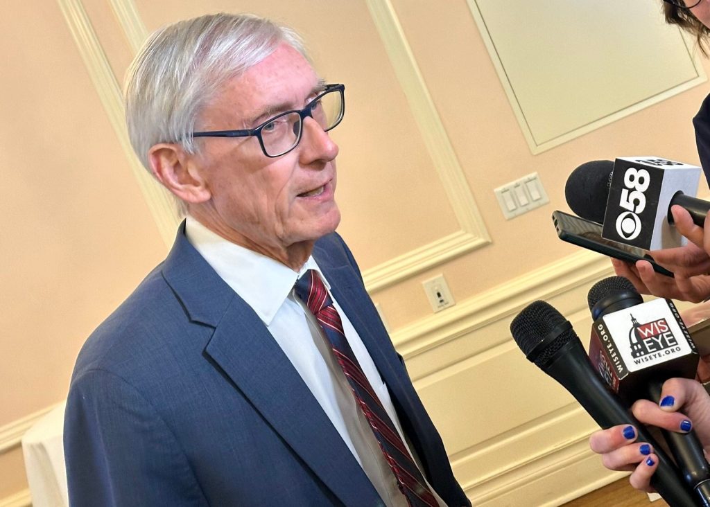 Gov. Tony Evers addresses reporters after a luncheon event hosted by WisPolitics at the Madison Club on Feb. 26, 2026, in Madison, Wis. Anya van Wagtendonk/WPR